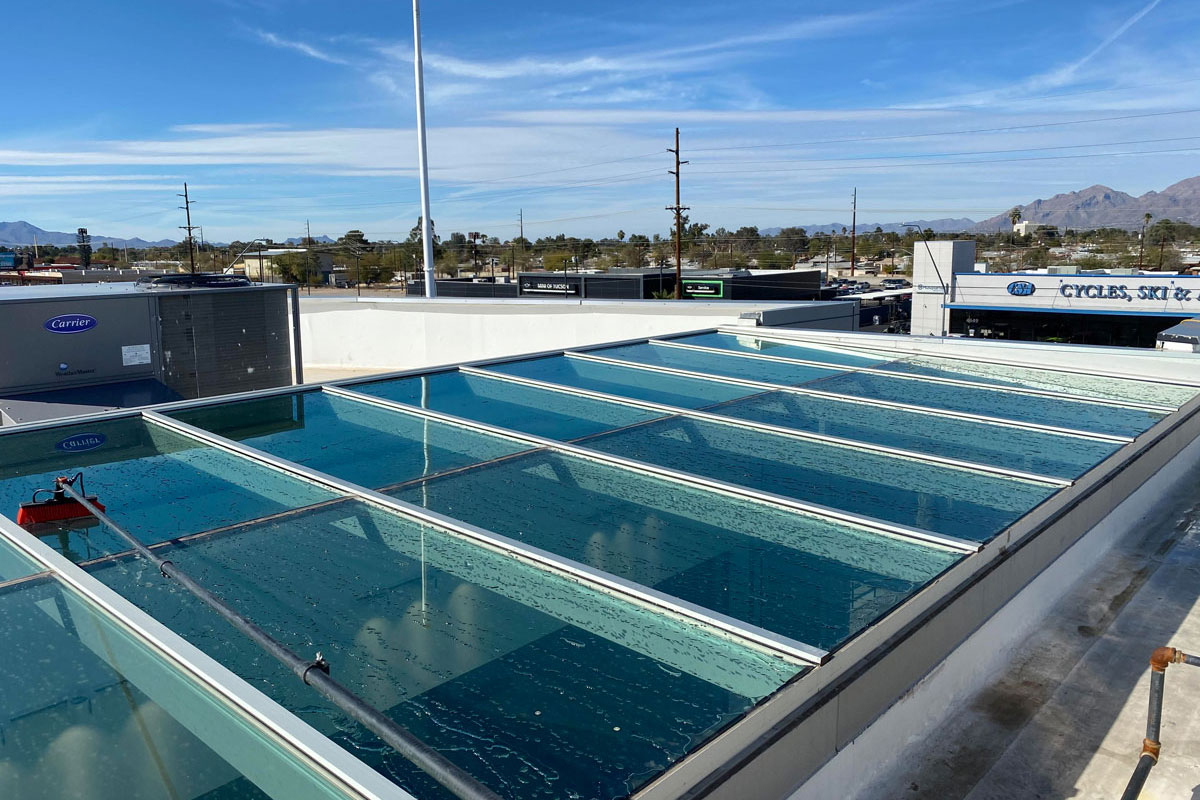Using water-fed pole to clean large glass roof