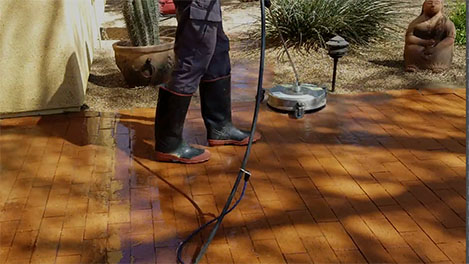 Powerwashing a stone patio and protecting the plants on the edges