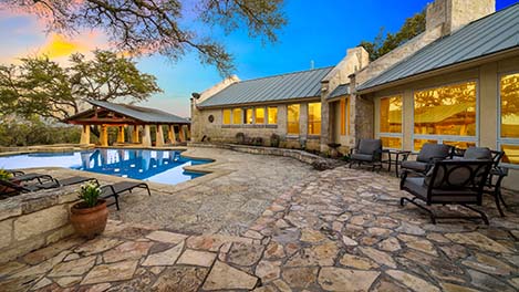 Around the luxury pool, a flag stone deck and patio which have been power washed. Patio furniture also power washed to remove algae.