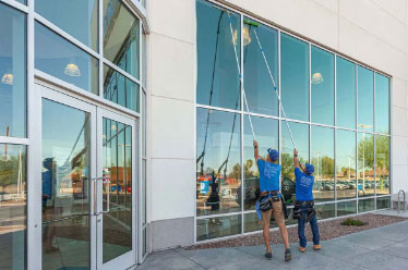Cleaning high windows with a water-fed pole